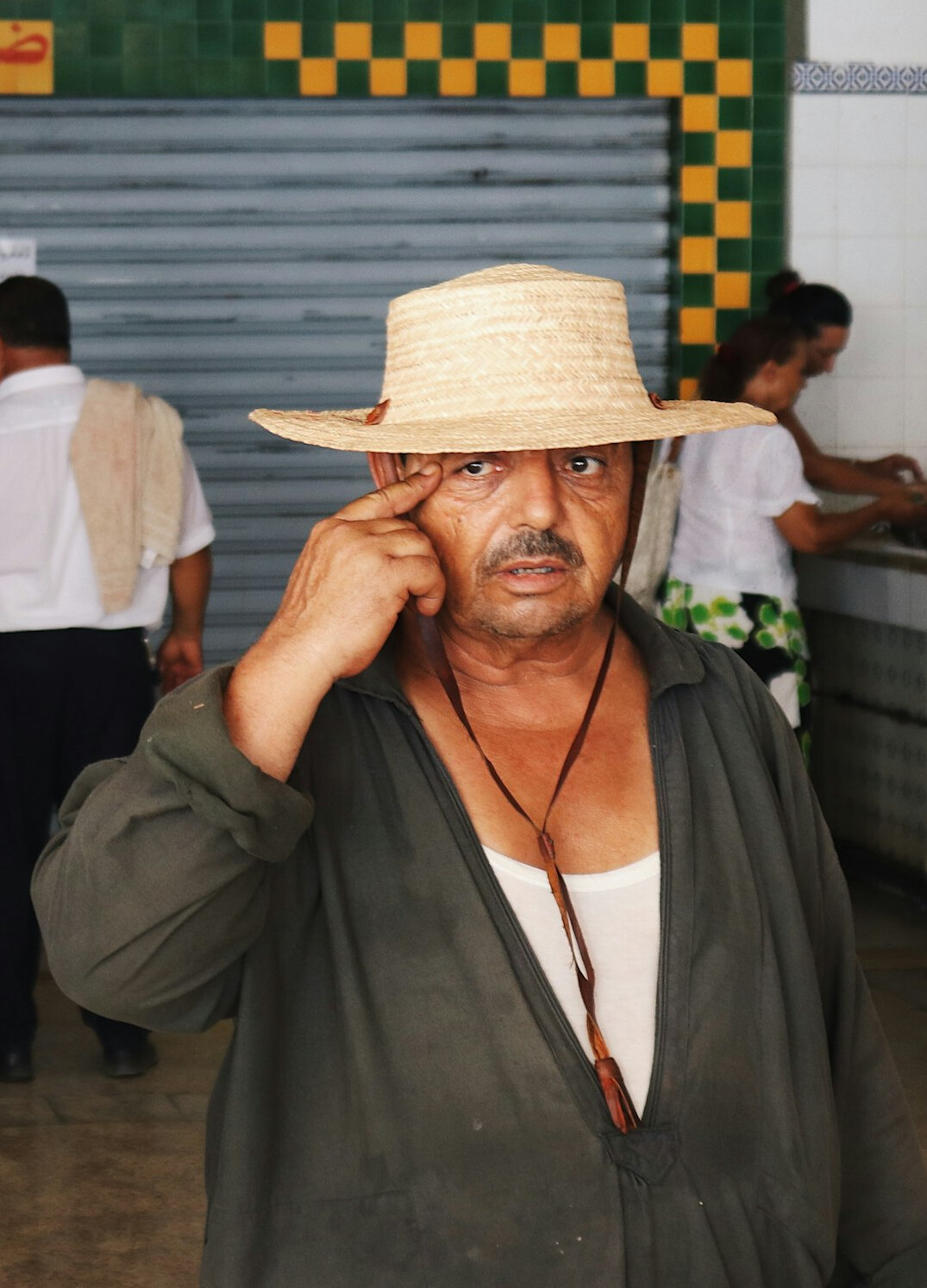 Studio portrait of an older Brazilian man with glasses