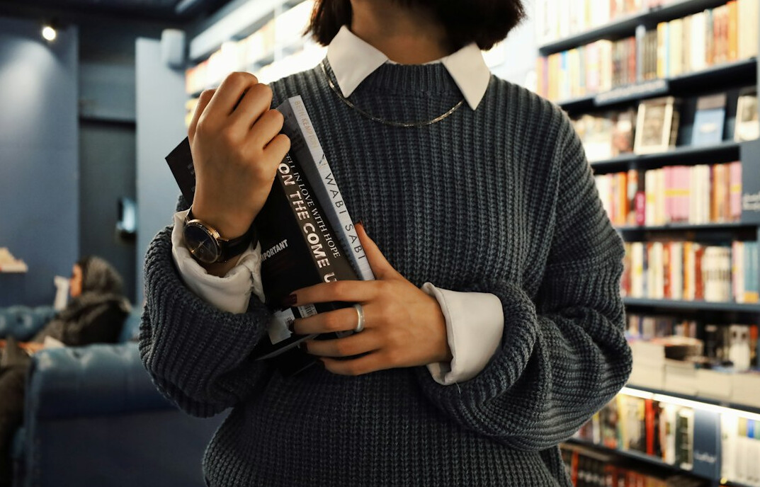 person reading book in library