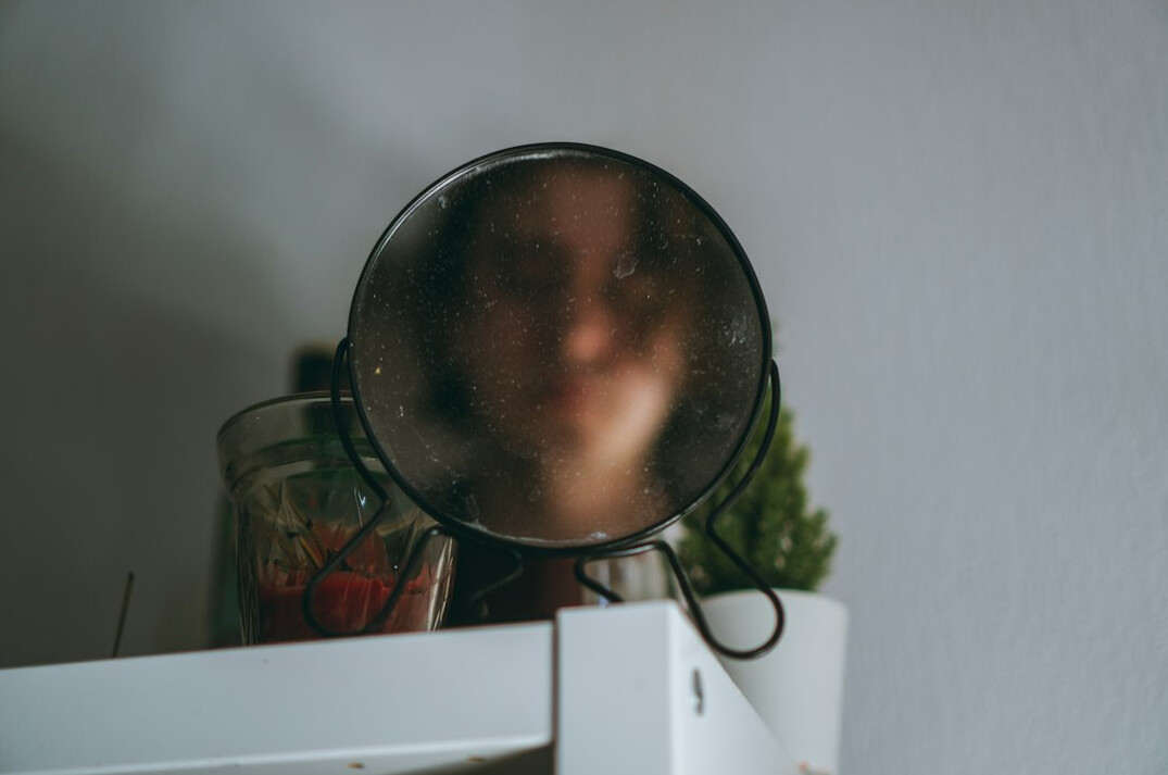 person reflecting in mirror