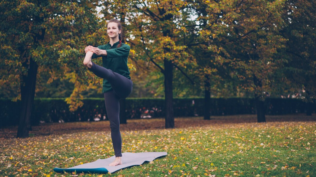 person doing yoga outdoors