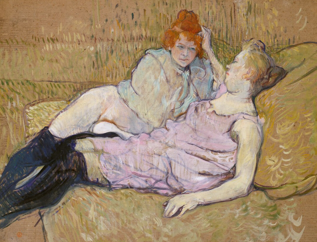Two women having an attentive conversation on a sofa